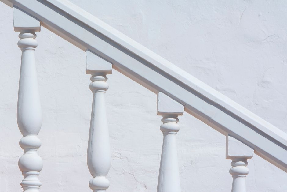 Why Stair Railings Feel Loose: Diagnosing Movement at the Newel, Tread, and Wall