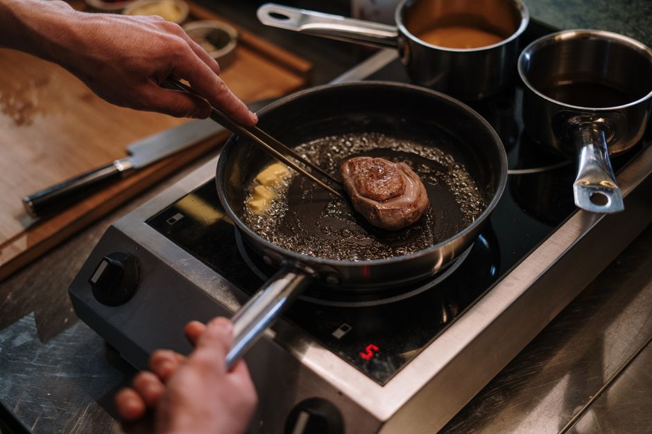 Why Induction Cooktops Heat the Pan Instead of the Kitchen