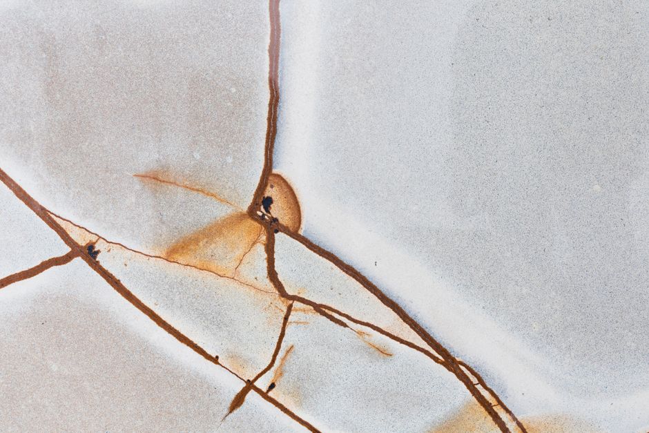 Garage Slab Cracks and Driveway Settling: Cosmetic Flaws or Functional Warning Signs?